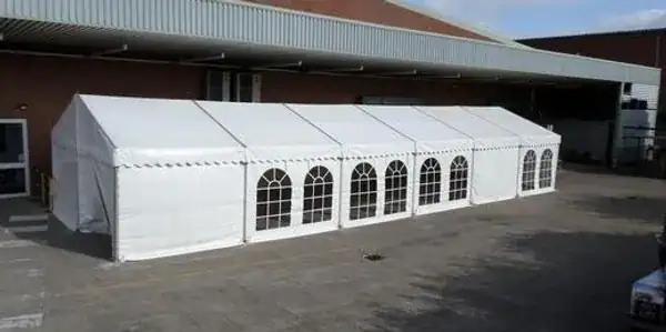 White marquee tent set up outdoors for events in Leicester area.