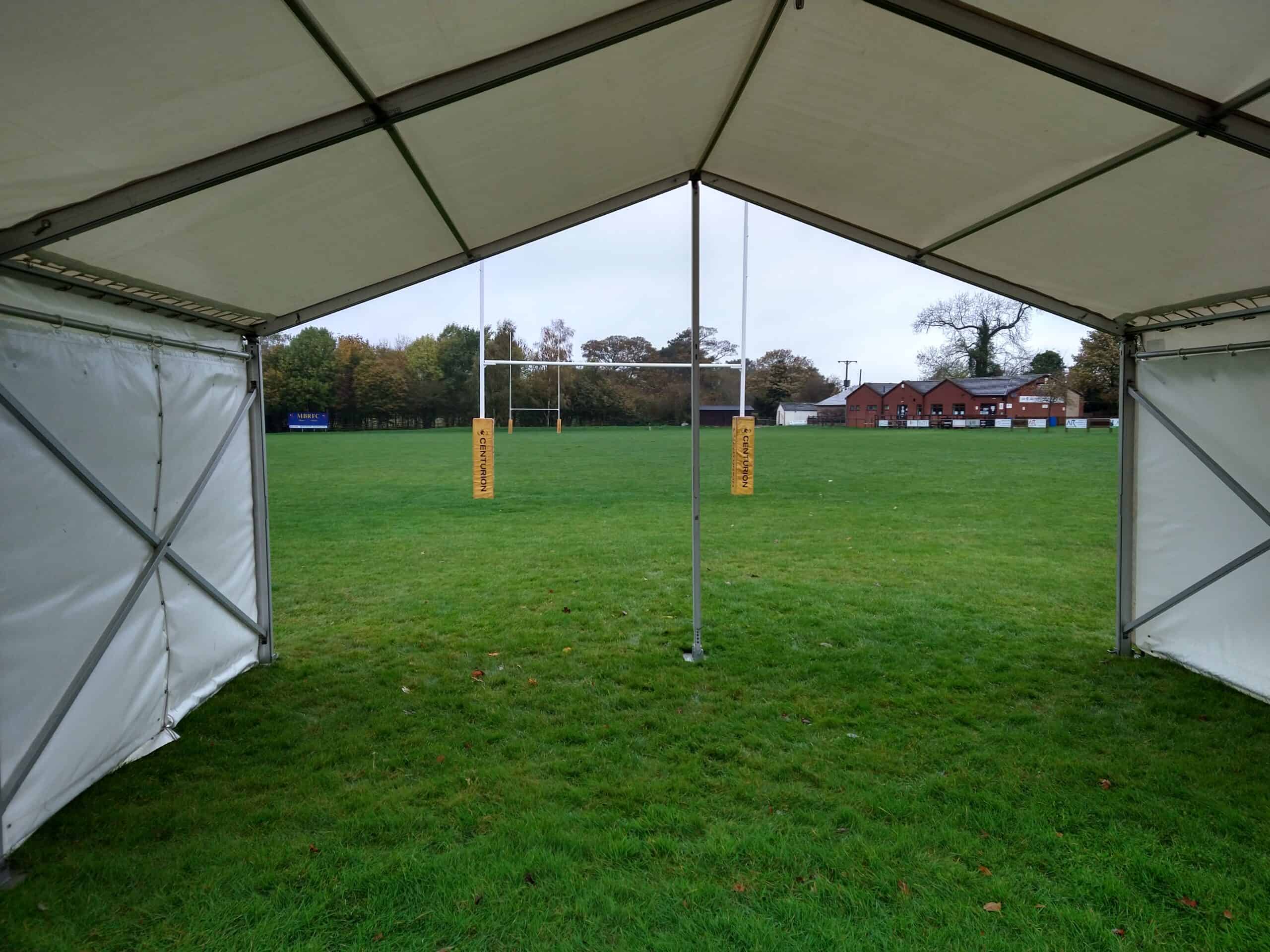 Versatile marquee setup on a lush green field in Leicester, ideal for outdoor events and gatherings.